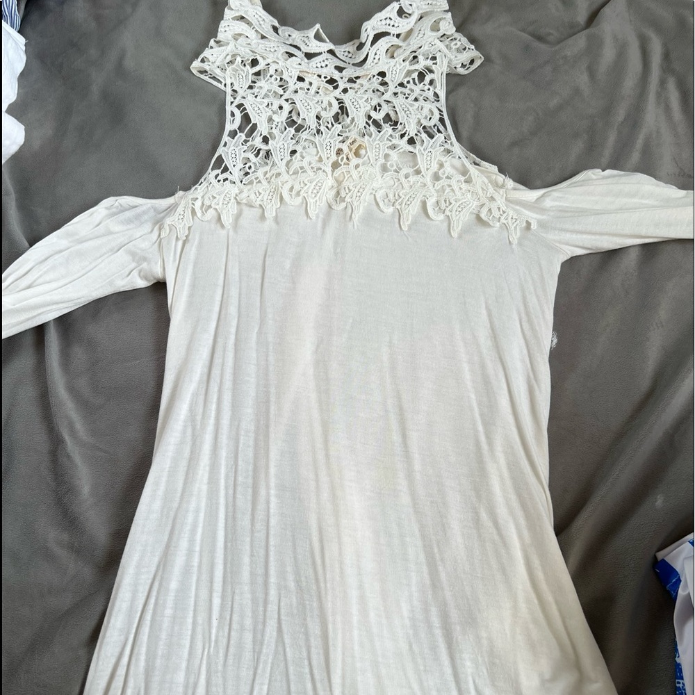 Very cute laced turtle neck with sleeves cut out shoulders.
